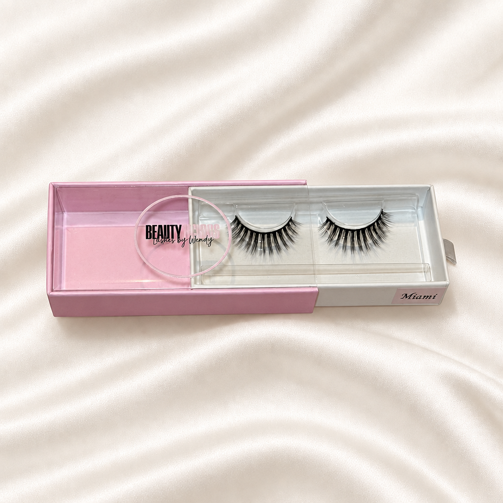 Miami faux lashes in pink packaging on soft ivory satin