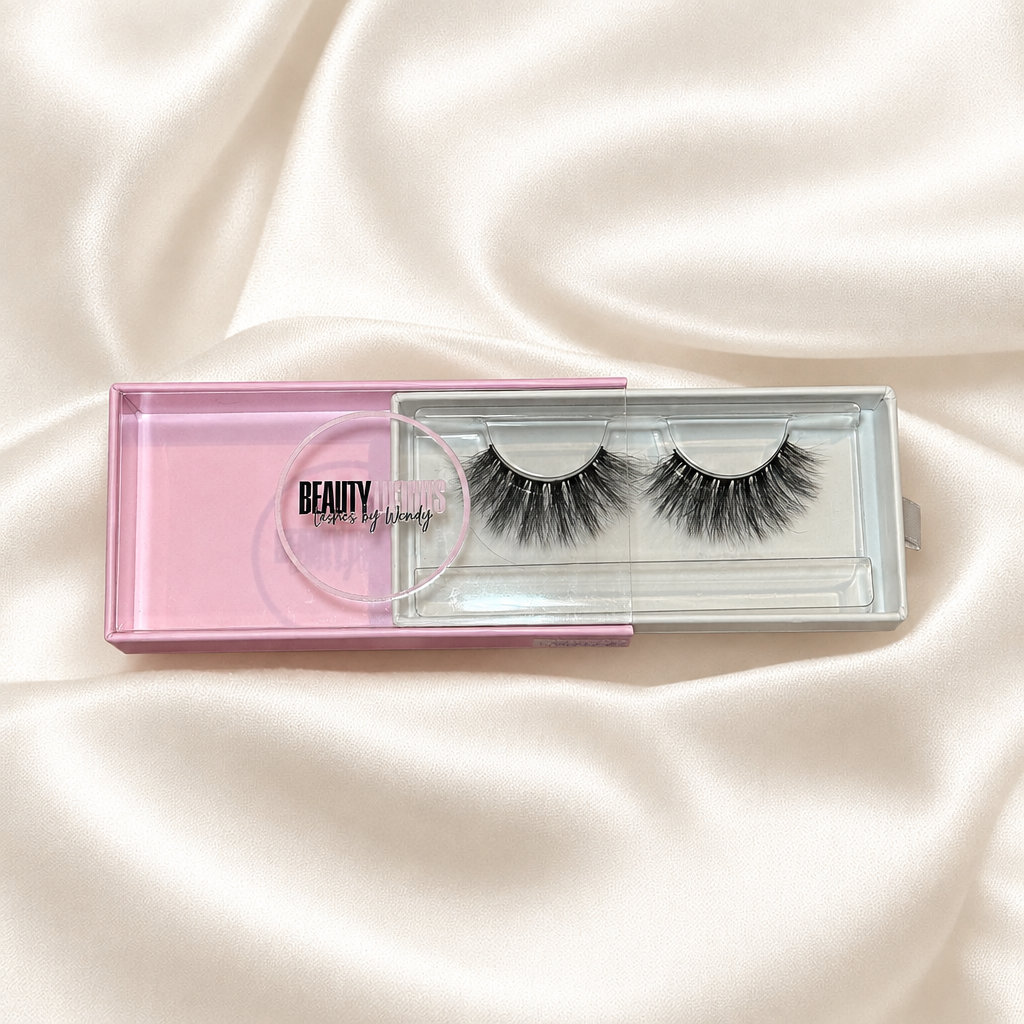 Sherly faux lashes in pink packaging on soft ivory satin