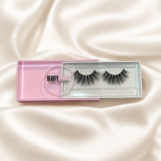 Sherly faux lashes in pink packaging on soft ivory satin