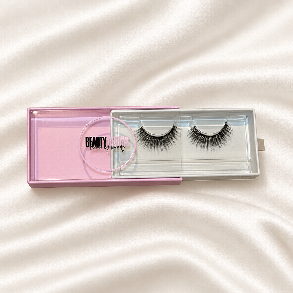 Dream faux lashes in pink packaging on soft ivory satin