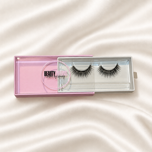 Dream faux lashes in pink packaging on soft ivory satin