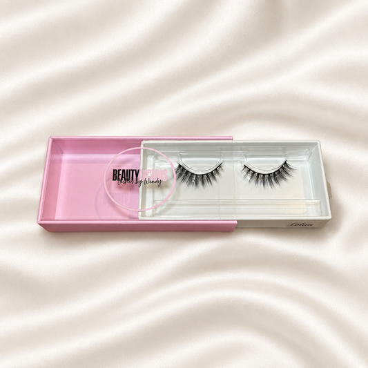 Lolita faux lashes in pink packaging on soft ivory satin
