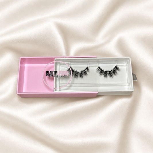 Jasiel faux lashes in pink packaging on soft ivory satin