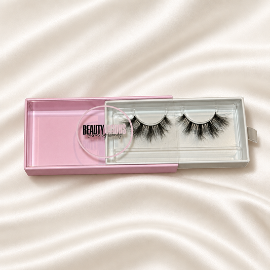 Tokyo faux lashes in pink packaging on soft ivory satin