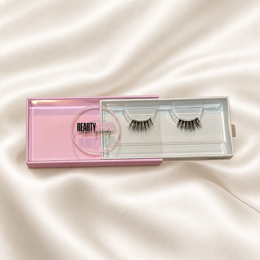 Classy faux lashes in pink packaging on soft ivory satin
