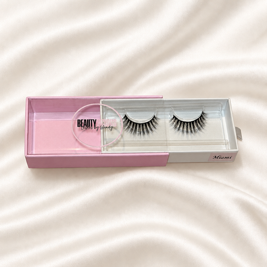 Miami faux lashes in pink packaging on soft ivory satin