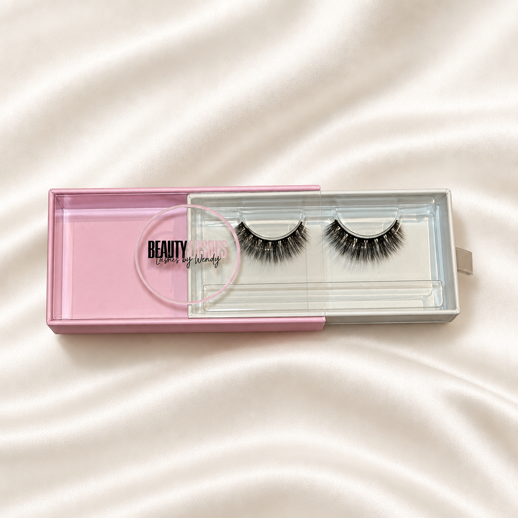 Maria faux lashes in pink packaging on soft ivory satin