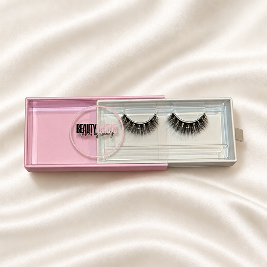 Maria faux lashes in pink packaging on soft ivory satin