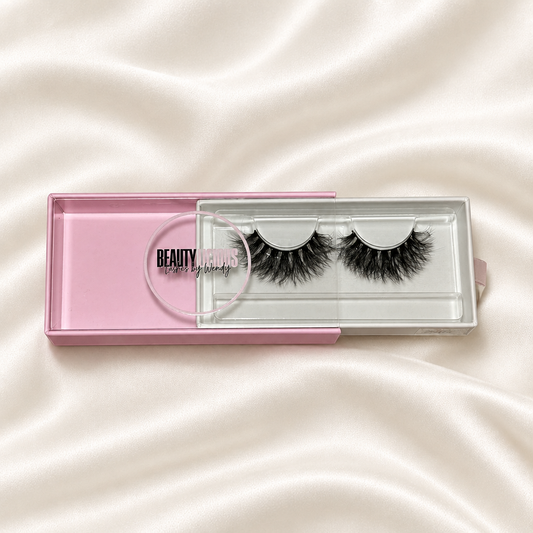 Bella lashes in pink packaging on soft ivory satin