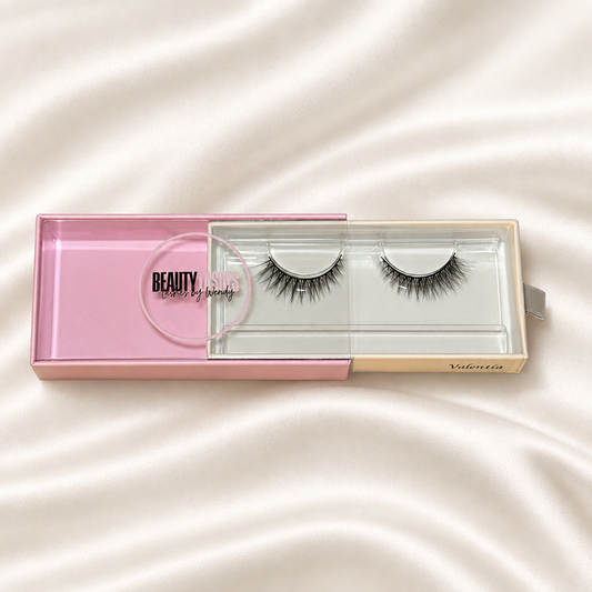 Valentina faux lashes in pink packaging on soft ivory satin