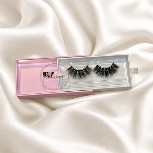 Bossy faux lashes in pink packaging on soft ivory satin