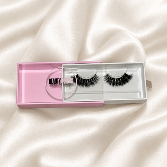 Bambi lashes in pink packaging on an ivory satin background