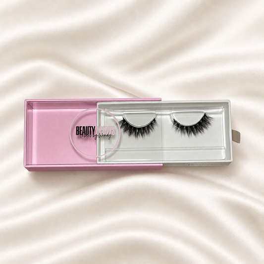Heartbreaker faux lashes in pink packaging on soft ivory satin